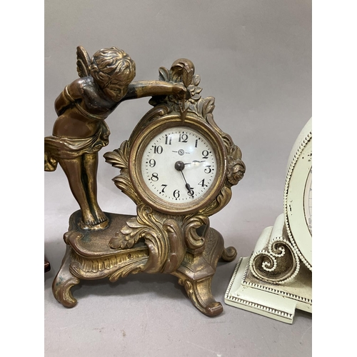 120 - A mahogany crossbanded mantel clock, a gilt metal boudoir clock formed as a winged cherub and anothe... 