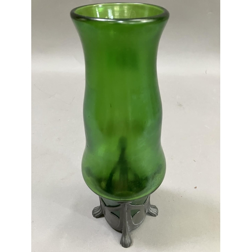 6 - A Loetz style vase of opaque lustre green glass within a pewter stand on four feet, 27cm high