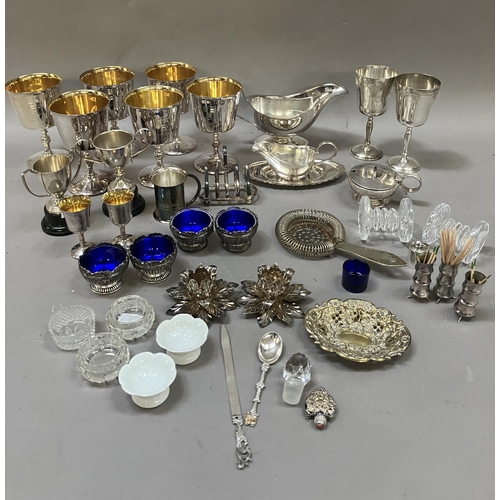 119 - A collection of silver plated ware comprising six goblets, jug, cruets, dishes, toast rack etc