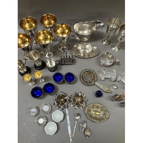 119 - A collection of silver plated ware comprising six goblets, jug, cruets, dishes, toast rack etc