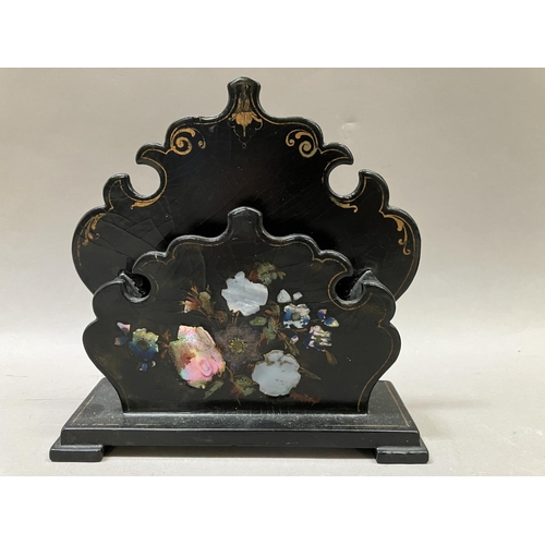 8 - A Victorian black lacquered inkstand, painted with gilt and inlaid with mother of pearl having two i... 