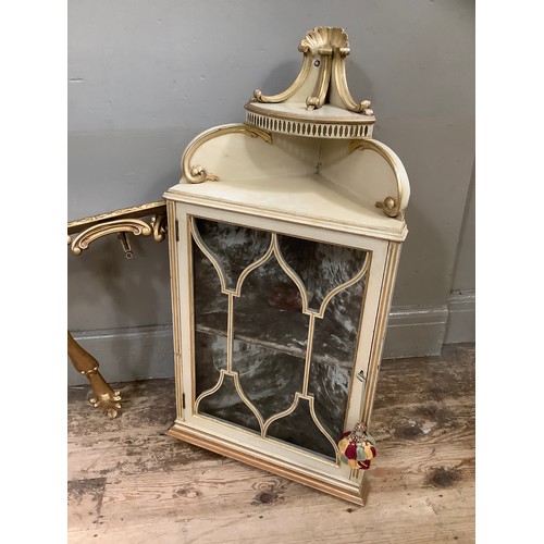 80 - A cream and gilt painted corner cupboard with glazed door and carved pediment, a gilt and marbled to... 