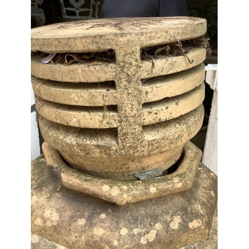 106 - A terracotta chimney pot, stamped base, 131cm high