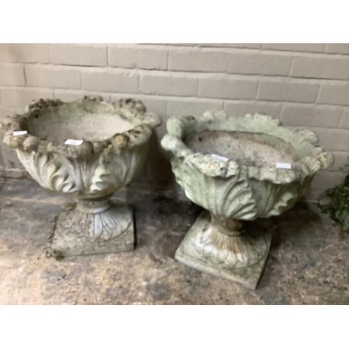 108 - A pair of cast, garden planters formed of acanthus leaves with a swept socles on a square base