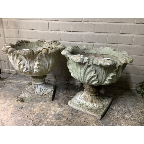 108 - A pair of cast, garden planters formed of acanthus leaves with a swept socles on a square base