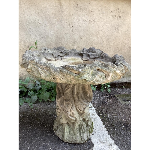 111 - A cast, garden planter formed of acanthus leaves with a swept socles with  square base together with... 