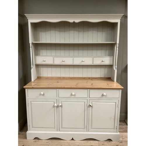 82 - A pine, painted, kitchen dresser in grey, having a plate rack above four drawers on a cupboard base ... 