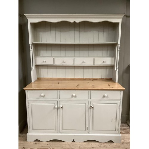 82 - A pine, painted, kitchen dresser in grey, having a plate rack above four drawers on a cupboard base ... 