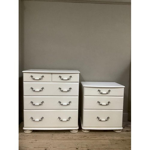 92 - A white chest of two short over three drawers having brushed chrome handles on bun feet together wit... 