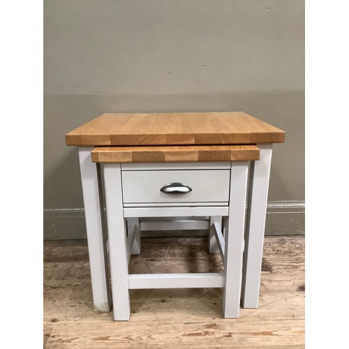 89 - A painted grey and oak nest of two tables, the smaller having a drawer