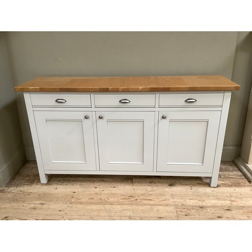 94 - A grey painted and oak topped sideboard having three drawers and three doors with brushed chrome han... 