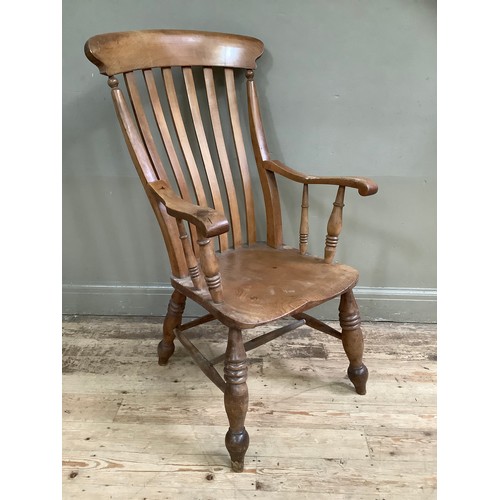 76 - A walnut 19th century kitchen chair on baluster supports and stretcher