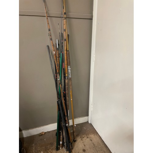 85 - A collection of fishing rods together with two CB radios