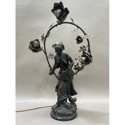 102 - After Auguste Moreau, a spelter lamp formed as a girl with chickens surmounted by a flowered arch ha... 