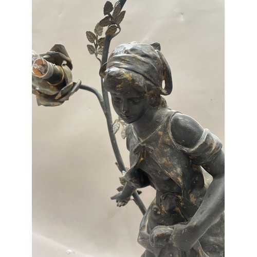 102 - After Auguste Moreau, a spelter lamp formed as a girl with chickens surmounted by a flowered arch ha... 