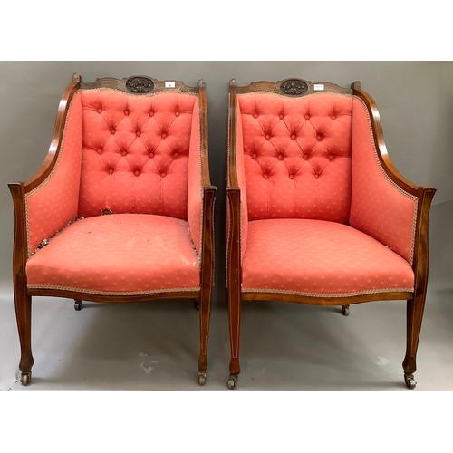 96 - A pair of Edwardian, inlaid, mahogany salon chairs with button backs upholstered in red fabric on ca... 