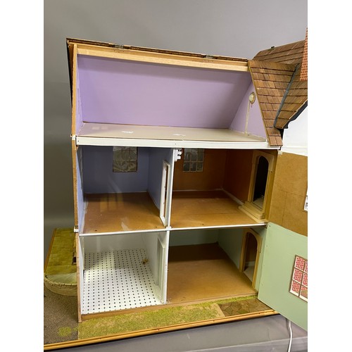 499 - A large dolls house on a wheeled plinth with opening front and rear, opening roof panels, a passenge... 