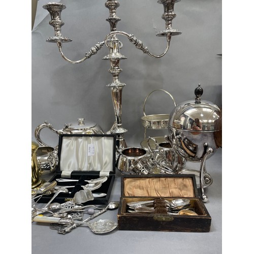 126 - A collection of silver plated ware to include a large candelabra, an egg coddler, a teapot,  sugar b... 