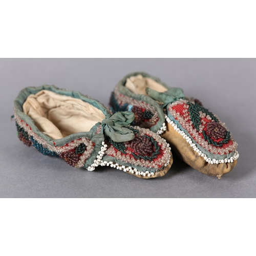 69 - A PAIR OF MID 19TH CENTURY CHILD'S BEADED SLIPPERS, worked in turquoise, teal, aubergine, green and ... 