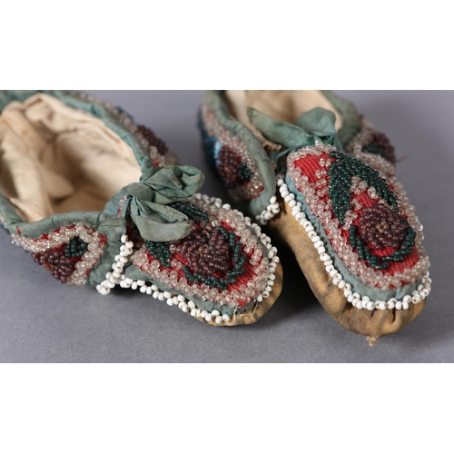 69 - A PAIR OF MID 19TH CENTURY CHILD'S BEADED SLIPPERS, worked in turquoise, teal, aubergine, green and ... 