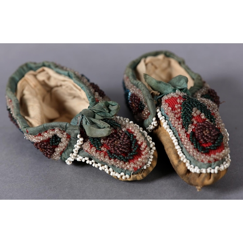 69 - A PAIR OF MID 19TH CENTURY CHILD'S BEADED SLIPPERS, worked in turquoise, teal, aubergine, green and ... 