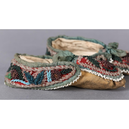 69 - A PAIR OF MID 19TH CENTURY CHILD'S BEADED SLIPPERS, worked in turquoise, teal, aubergine, green and ... 