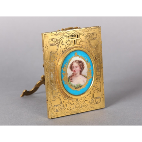 142 - A 19TH CENTURY FRENCH GILT BRONZE PERPETUAL CALENDAR, of rectangular form centered with a Sevres por... 