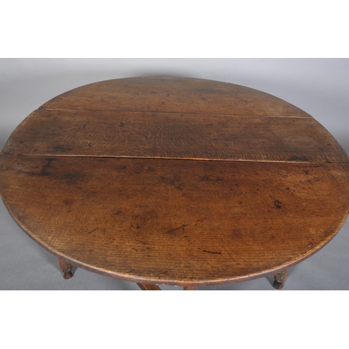 378 - AN 18TH CENTURY OAK OVAL GATELEG DINING TABLE having twin drop leaves, on turned and square framing,... 