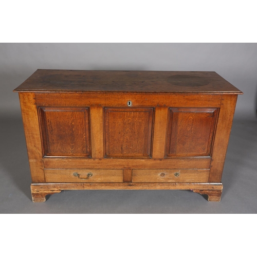 379 - AN 18TH CENTURY OAK MULE CHEST having a hinged top above a triple field panel front and two drawers,... 