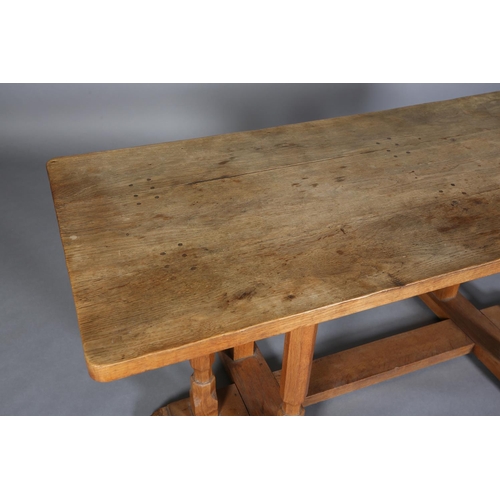 311 - SCHOOL OF THOMPSON OF KILBURN, An adzed oak rectory table c.1940s on triple chamfered leg standards,... 