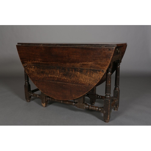 374 - AN 18TH CENTURY OAK OVAL GATELEG DINING TABLE having twin drop leavers and a drawer to either end wi... 