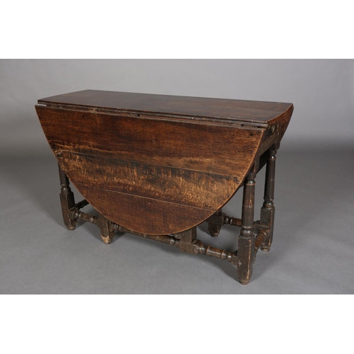 374 - AN 18TH CENTURY OAK OVAL GATELEG DINING TABLE having twin drop leavers and a drawer to either end wi... 