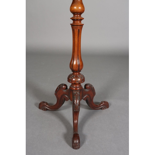 338 - A MID 19TH CENTURY MAHOGANY CIRCULAR TRIPOD TABLE having a recessed surface on a fluted and foliate ... 