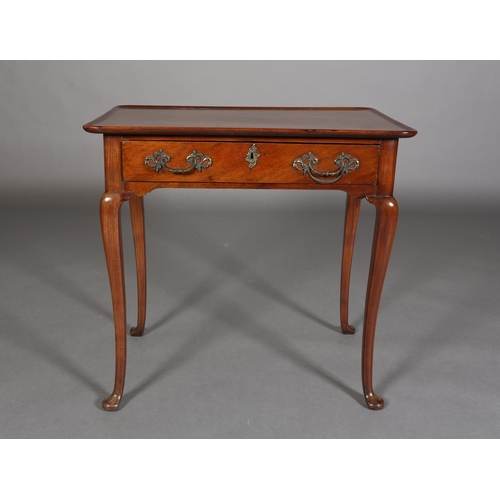 328 - A GEORGE III STYLE WALNUT SIDE TABLE with lipped surface above a frieze drawer, gilt rococco handles... 