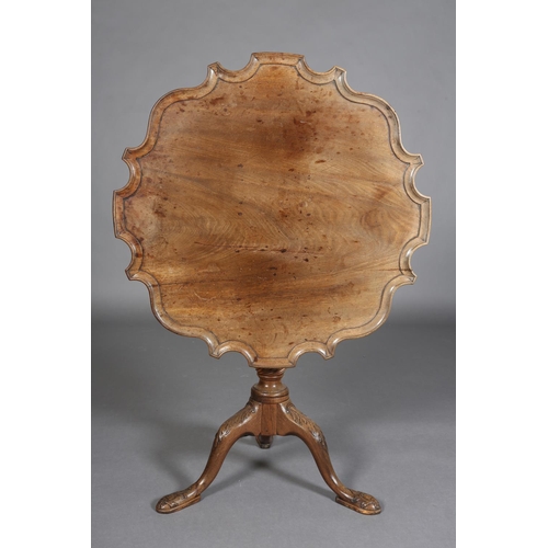 329 - A GEORGE III MAHOGANY TILT TOP TABLE, circular bracketed outline with moulded rim, on writhen turned... 