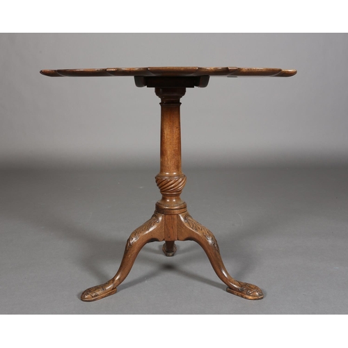 329 - A GEORGE III MAHOGANY TILT TOP TABLE, circular bracketed outline with moulded rim, on writhen turned... 