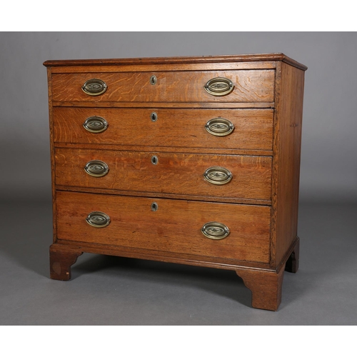 375 - AN EARLY 19TH CENTURY OAK CHEST of four graduated drawers with seashell embossed brass oval back pla... 