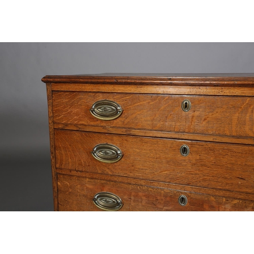 375 - AN EARLY 19TH CENTURY OAK CHEST of four graduated drawers with seashell embossed brass oval back pla... 