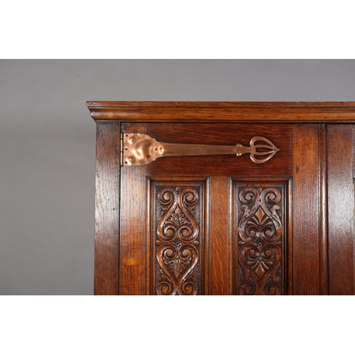 316 - AN ARTS & CRAFTS OAK HALL ROBE, having a moulded cornice above two foliate carved panels and four fu... 