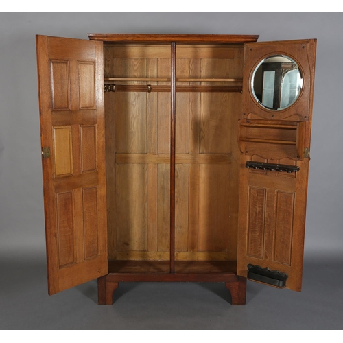 316 - AN ARTS & CRAFTS OAK HALL ROBE, having a moulded cornice above two foliate carved panels and four fu... 