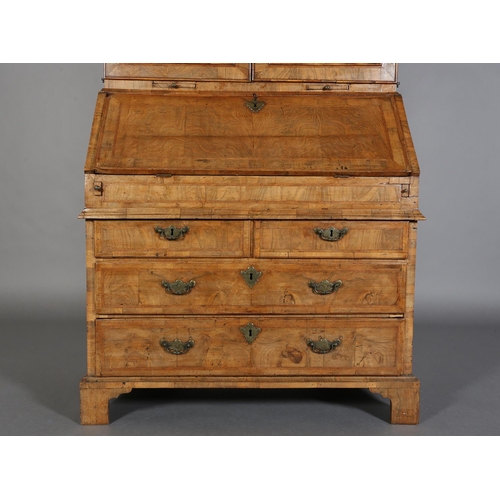 330 - AN EARLY GEORGE III FIGURED WALNUT AND CROSSBANDED BUREAU-BOOKCASE, having a moulded cornice above t... 