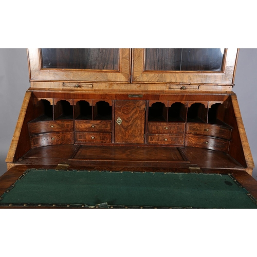 330 - AN EARLY GEORGE III FIGURED WALNUT AND CROSSBANDED BUREAU-BOOKCASE, having a moulded cornice above t... 