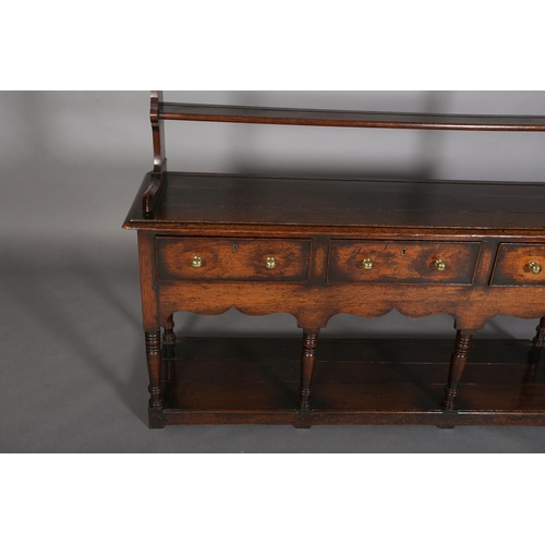 376 - A LATE 18TH CENTURY OAK DRESSER AND RACK, having a moulded cornice above three open shelves, the dre... 