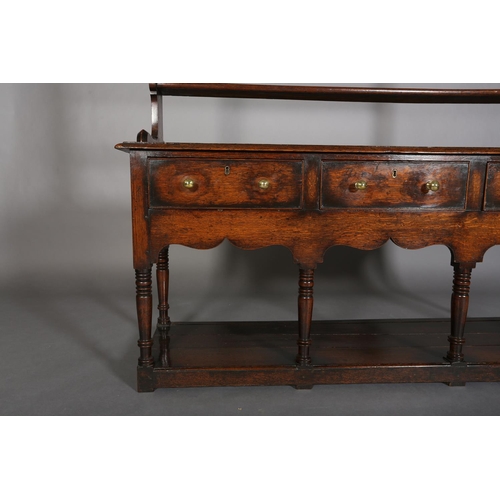 376 - A LATE 18TH CENTURY OAK DRESSER AND RACK, having a moulded cornice above three open shelves, the dre... 