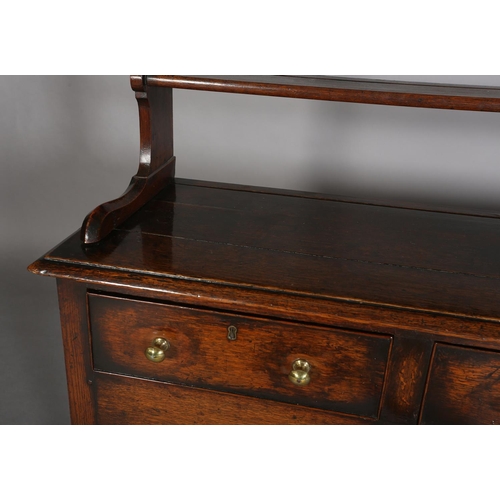 376 - A LATE 18TH CENTURY OAK DRESSER AND RACK, having a moulded cornice above three open shelves, the dre... 