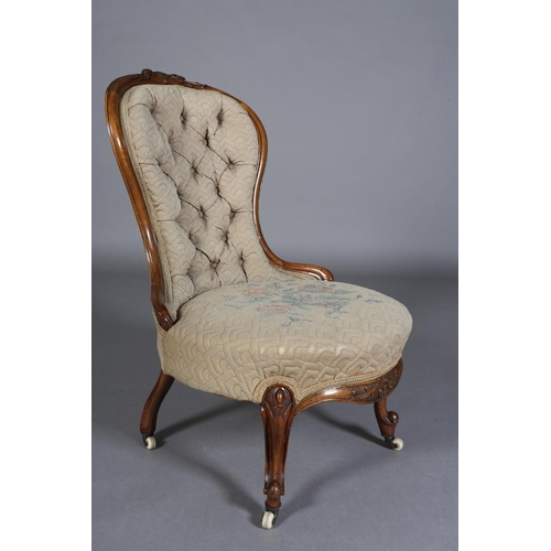 339 - A VICTORIAN WALNUT NURSING CHAIR having an encircling frame with foliate surmount, button back quilt... 