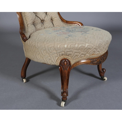 339 - A VICTORIAN WALNUT NURSING CHAIR having an encircling frame with foliate surmount, button back quilt... 