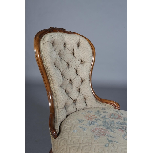 339 - A VICTORIAN WALNUT NURSING CHAIR having an encircling frame with foliate surmount, button back quilt... 