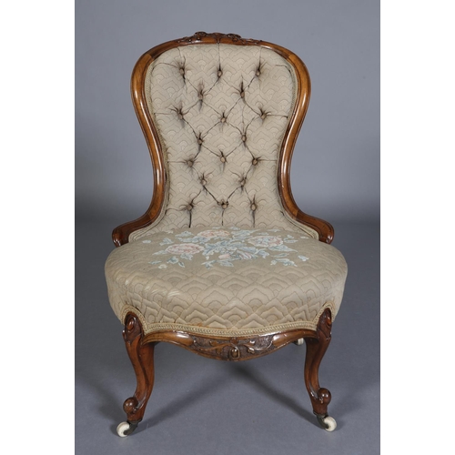 339 - A VICTORIAN WALNUT NURSING CHAIR having an encircling frame with foliate surmount, button back quilt... 