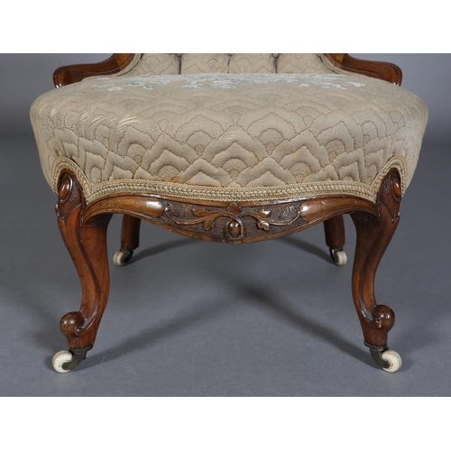 339 - A VICTORIAN WALNUT NURSING CHAIR having an encircling frame with foliate surmount, button back quilt... 